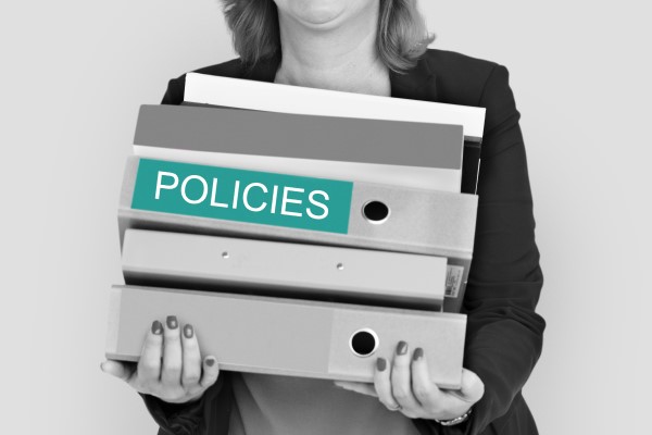 Woman holding policy folders
